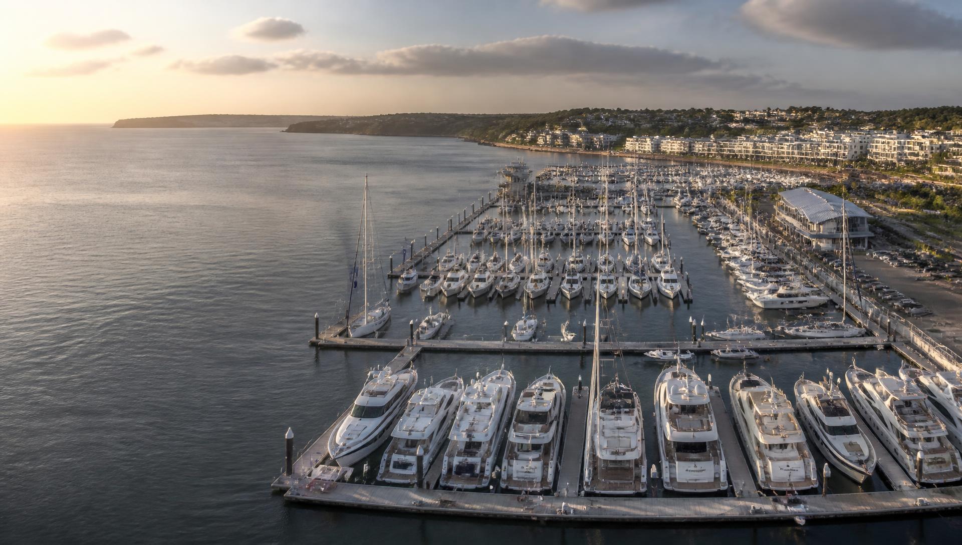 Yachts moored in a European marina at golden hour